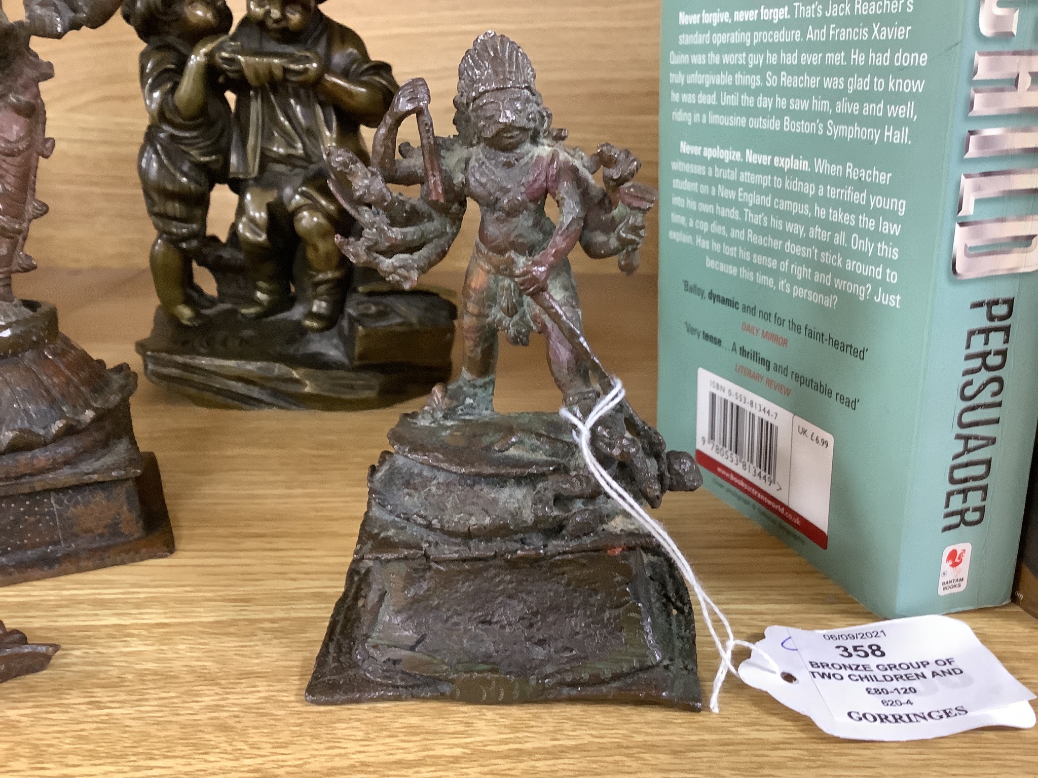 A bronze group of two children and two Indian bronze figures, tallest 20cm